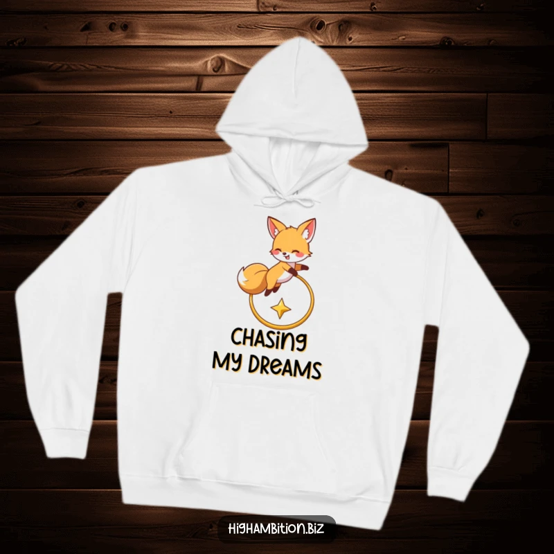 Funny hoodie showing a happy fox character soaring over a golden hoop, eyes fixed on a shining star, embodying playful determination.